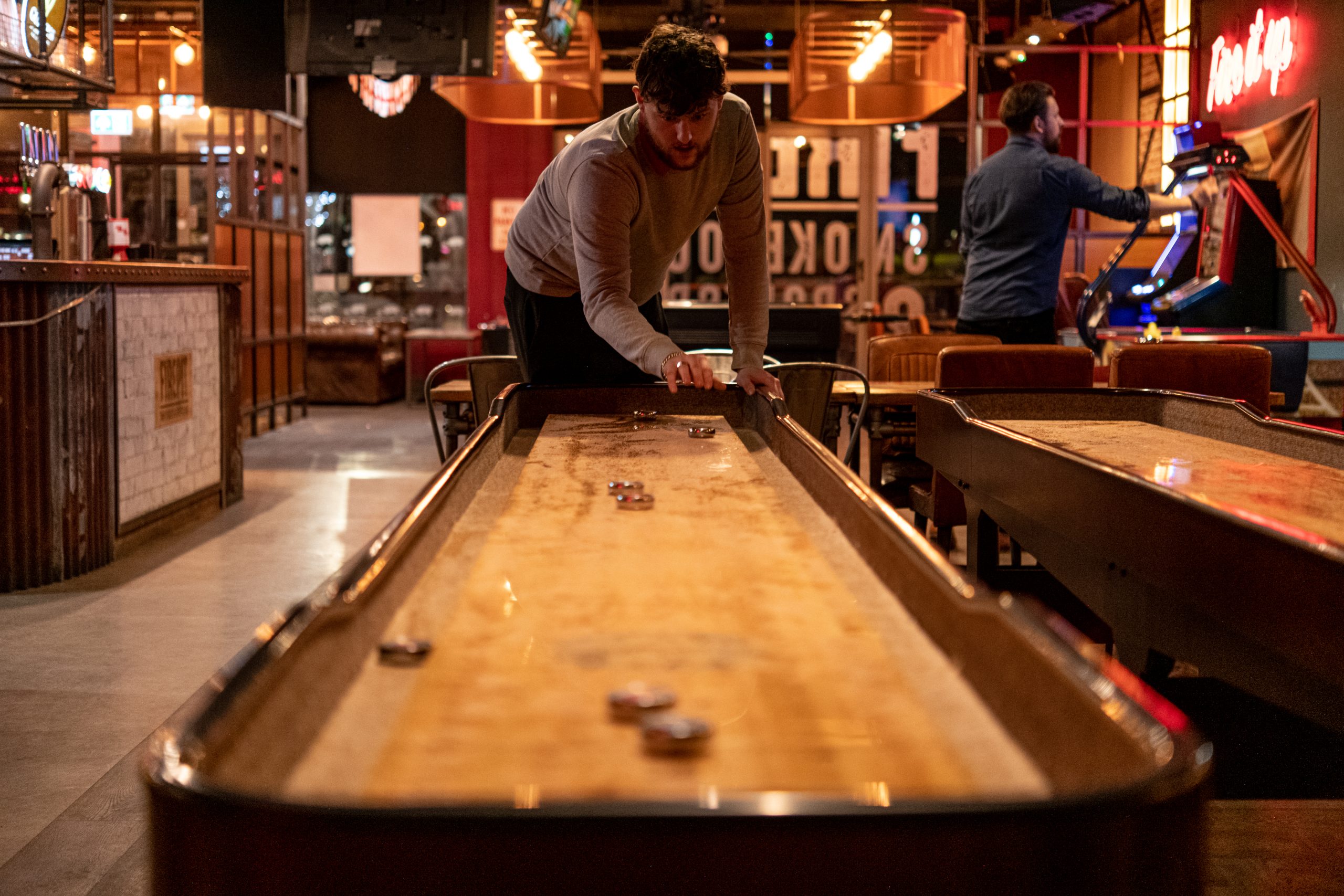 Enjoy a game of shuffleboard with friends at Firepit bars