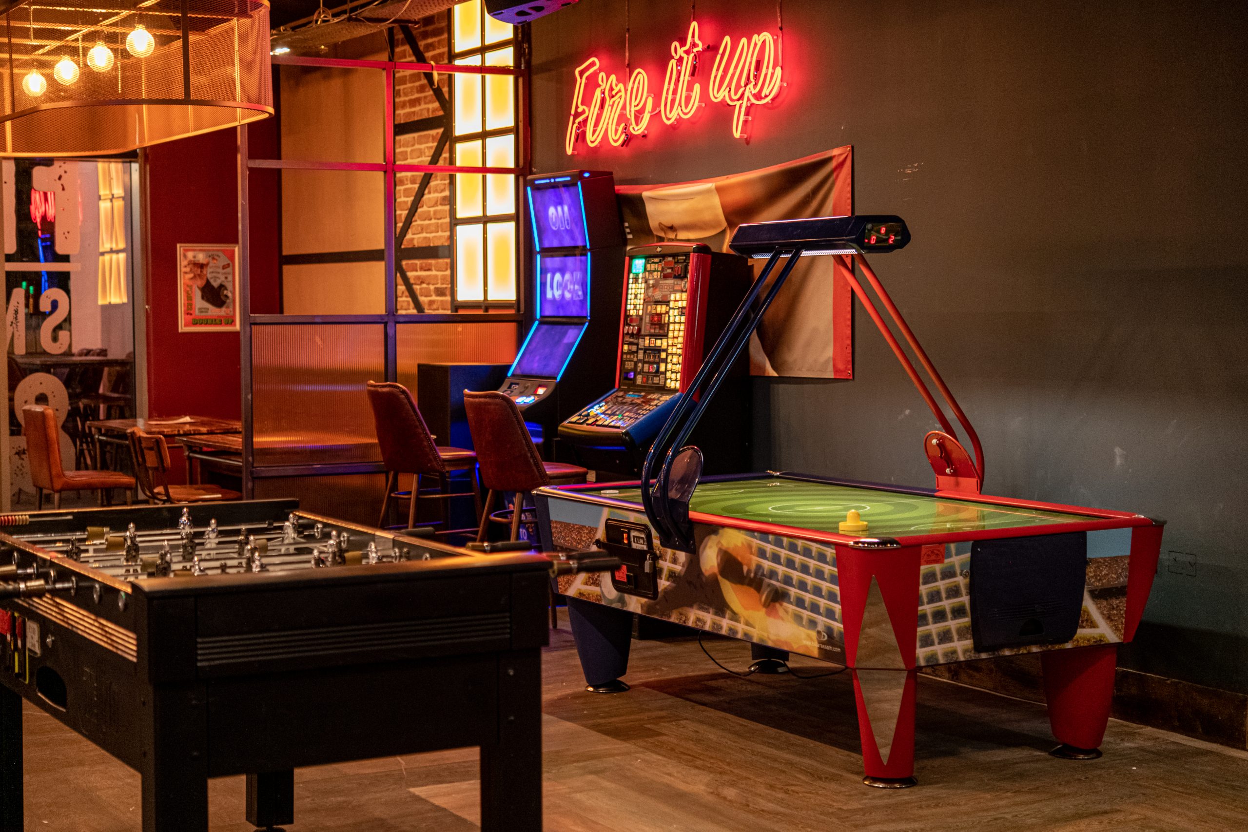 Enjoy a game of air hockey with friends at Firepit bars